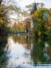 View on tower in Augsburg during autumn with water reflections
