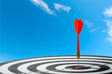 dart arrow hitting in the target center of dartboard. concept of the success