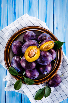 Plums on wooden table 