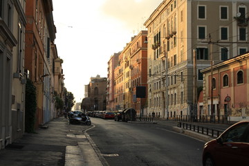 Fototapeta na wymiar Empty street in Rome in the sunset light, summer, Italy