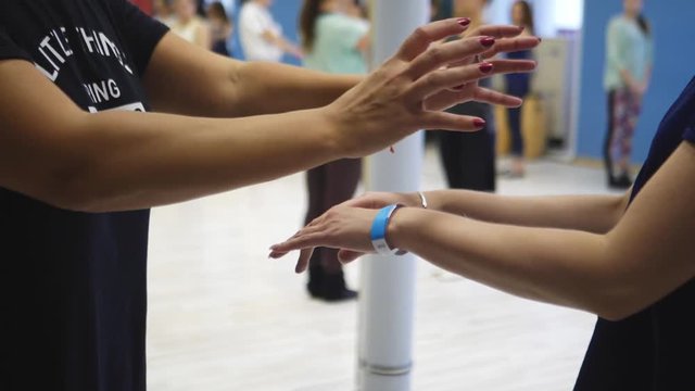 Hands of two girls in dance, master class on salsa. Dance School Workout