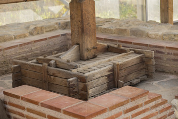 The ancient tradition of grape processing. The squeezer is used to press the wine. Excavation of...
