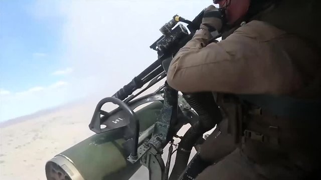 American soldier firing from armed helicopter during combat training