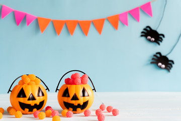 Halloween crafts, orange pumpkin with colorful jelly on wooden table with copy space for text. halloween concept.