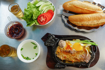Bo Ne, a traditional Vietnamese breakfast with steak, eggs and crispy baguete.