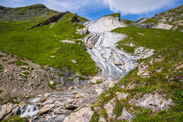 Dramatic Rocky Mountain on Mont-Blanc Trail with Stream and Wild Flowers
