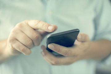 Close-up view. Man using a phone. Selective focus