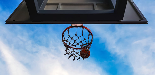 basketball hoop and ball on the sky background © domarevatanya