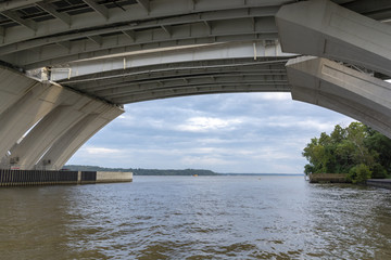 Below the Woodrow Wilson Memorial Bridge, which spans the Potomac River between Alexandria, Virginia, and the state of Maryland, as seen from Jones Point Park in Alexandria.