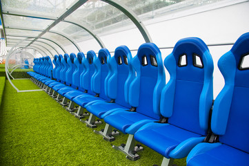 Naklejka premium Blue bench or seat or chair of staff coach in the stadium of football