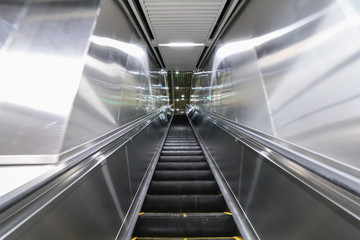 Escalator in the city leading to the underground passage of the subway