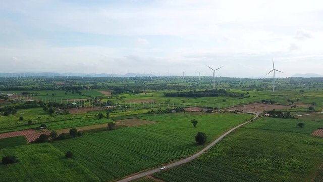 Aerial view of Windmills for electric power production at Huai Bong, Dan Khun Thot district, Nakhon Ratchasima. Large wind turbines were surrounded by corn field, Potato field and sugarcane field
