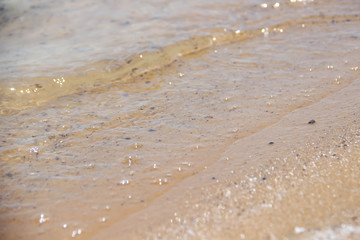Background Brown sand through the clear waters of the dead sea