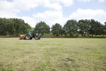 tractor drives on pasture