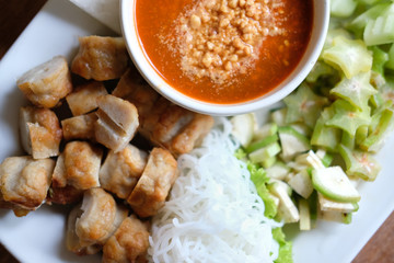 minced pork sausage, fermented rice noodle & vegetable served with chili sauce. vietnamese food called Nem Nuong Xa
