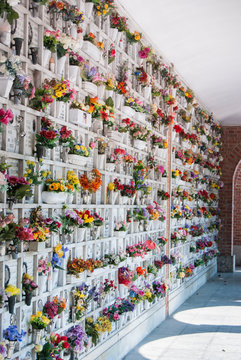 Loculi of a cemetery with plastic flowers