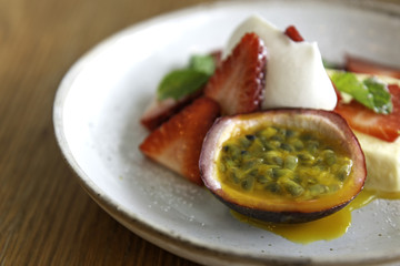 Passion fruit ice cream With fresh strawberries and passion fruit, topped with whipped cream and sprig of fresh peppermint.