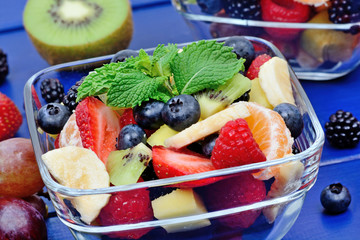 Fruit salad in a bowls on wooden table