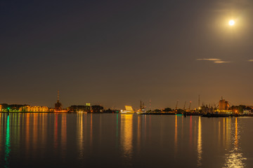 Fototapeta na wymiar a harbor at night with light from the moon and long exposure