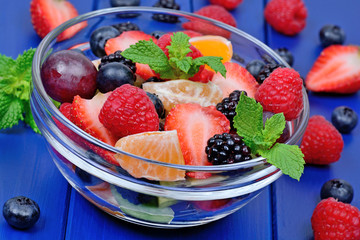 Colorful fruit salad in a transparent bowl