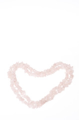 This heart shaped love pattern or background was created for Valentine's Day and was made of rose quartz crystal necklace.