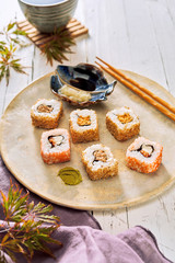 Serving of healthy uramaki sushi with soy sauce