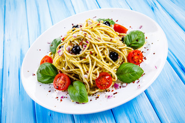 Pasta with vegetables on wooden table