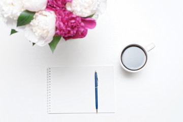 Workplace with paper cup coffee pen pink white peony flowers