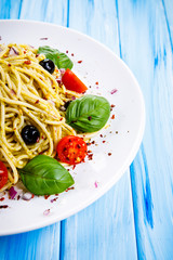 Pasta with vegetables on wooden table