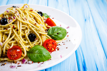 Pasta with vegetables on wooden table