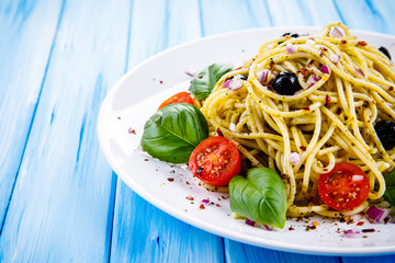 Pasta with vegetables on wooden table