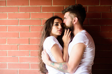 Moments of intimacy. Couple in love hugs brick wall background. Couple find place to be alone. Girl and hipster romantic date intimacy moment. Couple enjoy intimacy cuddling without witnesses