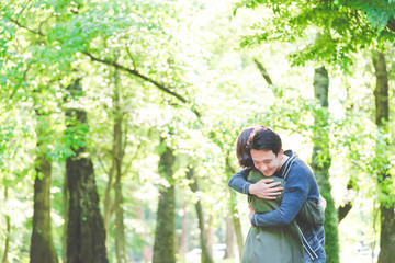 新緑の中、抱き合うカップル