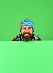 Hipster with beard and smiling face wears warm clothes