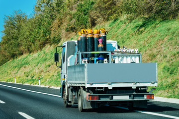 Truck with gas cylinders on road in Italy