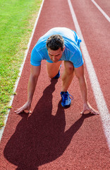Runner take part competitions low start position. Focused on sport goal. Ready to achieve victory....