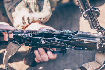 The boy performs disassembly, cleaning and assembly of AK-47, an automatic rifle Kalashnikov