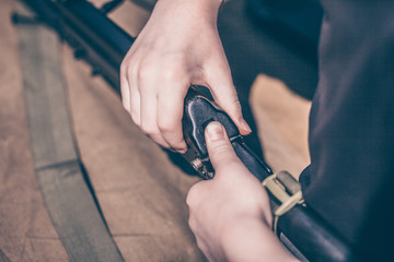 The boy performs disassembly, cleaning and assembly of AK-47, an automatic rifle Kalashnikov