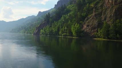 Beautiful drone flight over the still water of the Yenisei river