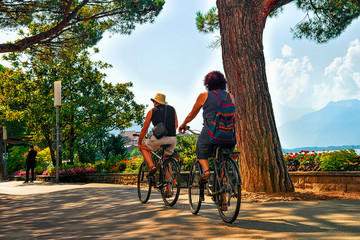 Couple riding bicycle embankment of Geneva Lake Montreux Riviera