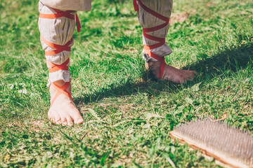 A person prepares to step on a board with sharp nails, traditional medicine and yoga