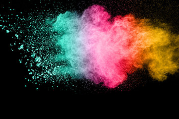 Multicolored powder explosion on black background.