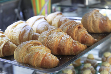Close up of a tray full of croissant (brioches). Concept: Breakfast, bar, sweet