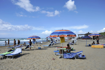 Relaxed people on the Sabaudia beach for the summer holidays. The sea on the background. Sabaudia, Lazio, Italy.