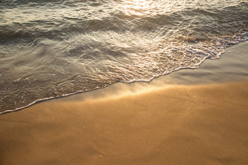 the shore of the sea wet sand with a wave of clear water