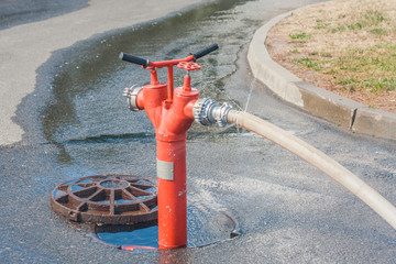 open fire hydrant with hose connected