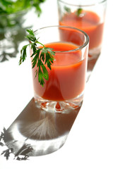 A glass of fresh tomato juice and tomatoes, parsley