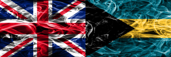 United Kingdom vs Bahamas smoke flags placed side by side. Thick colored silky smoke flags of Great Britain and Bahamas