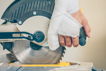 Bandaged hand injured with a circular saw