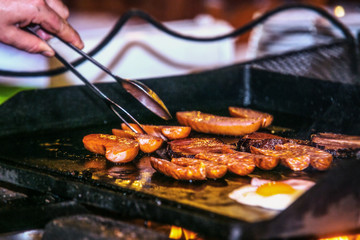 Close up hands of chef preparing food in the kitchen of a restaurant, cooking concept